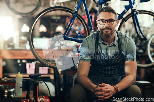 Image of Portrait, mechanic and man in bicycle shop, store and cycling workshop for repairs. Entrepreneur, bike technician and mature male person, small business owner and retail service expert from Canada