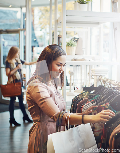 Image of Retail, customer and woman with fashion, luxury and shopping with boutique items, selection and happiness. Female shopper, client and lady with clothes, sales discount and outfit choice in a store