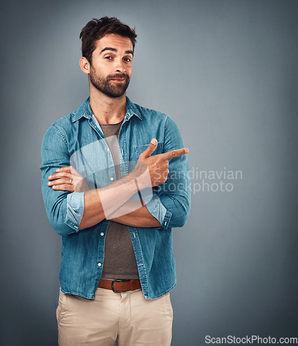 Image of Point, hands and portrait of man in studio on gray background for announcement, news and information. Fashion, mockup space and male person with pointing hand sign for promotion, choice and decision