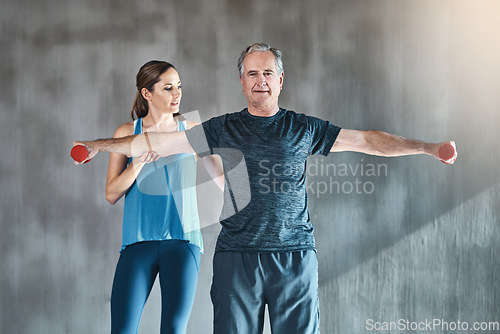 Image of Physiotherapy, dumbbell and fitness with senior man and personal trainer for support, health or workout. Training, weightlifting or coaching with old patient and physiotherapist for help and wellness