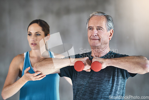 Image of Coaching, dumbbell and fitness with old man and personal trainer for support, health and physiotherapy. Training, weights and senior patient workout with woman, physiotherapist and help for exercise