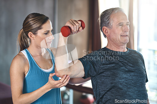 Image of Support, dumbbell and coaching with old woman and personal trainer for help, health or physiotherapy. Training, weightlifting and fitness with senior patient and physiotherapist for elderly workout