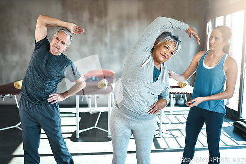 Image of Stretching, help and old couple with personal trainer for fitness, wellness and physiotherapy. Health, workout or retirement with senior patient and physiotherapist in gym for warm up training