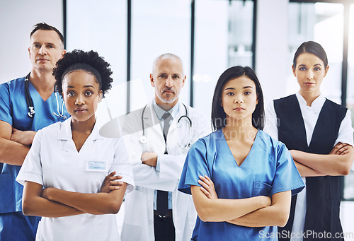 Image of Medical, crossed arms and portrait of group of doctors standing in the hallway with confidence. Serious, diversity and team of professional healthcare workers in a medicare clinic or hospital.