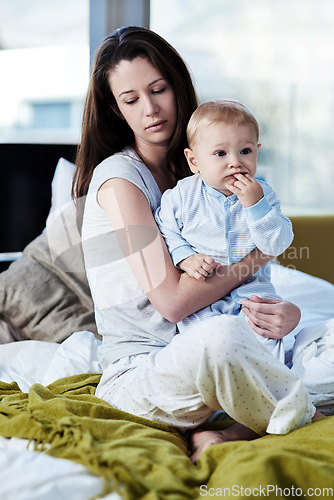 Image of Baby, mother and sad with postpartum on bed at family house and problem with stress or being tired. Mom, newborn and depression with mental health at home with insomnia about child development.