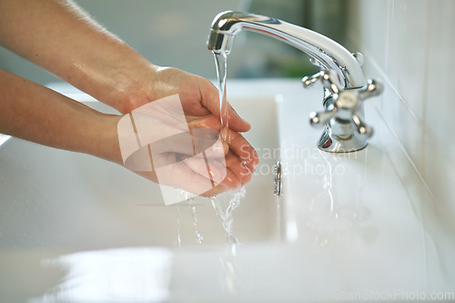 Image of Clean, bathroom and hands with water for wash or dirt, bacteria and safety from germs at home. Woman, cleaning and hand for self care for healthy person for disinfection and hygiene at the house.