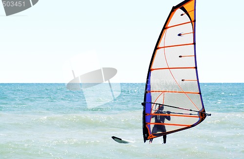 Image of Silhouette of a windsurfer on the sea in the afternoon