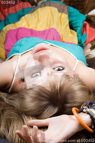 Image of The young beauty woman lies on a bed