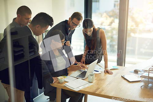 Image of Business meeting, laptop and group of people with website review, online launch and discussion or teamwork. Corporate, professional or women and men reading, check or planning on computer in office