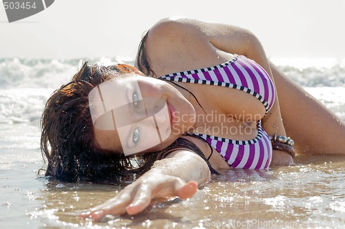 Image of The young woman lies on sea coast