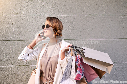 Image of Phone call, shopping bag and woman outdoor for online sales, discount or promotion of fashion. Mobile news, gift offer and rich customer or person with clothes, sunglasses and chat in city street