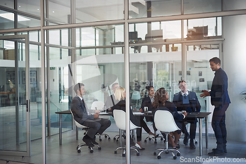 Image of Executive, meeting and group in office room for corporate planning, strategy or business training. Management, people at table and businessman or speaker, mentor and professional advice to company