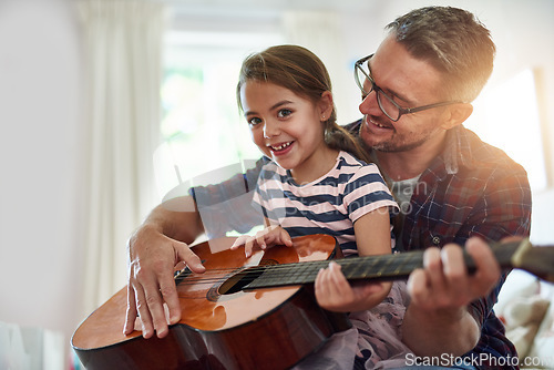 Image of Father, guitar and teaching a girl in portrait with happiness at home for fun or love or bonding. Music, acoustic and instrument with parent and daughter for learning or care with music together.