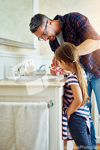 Image of Father, girl and brushing teeth in bathroom, bonding and cleaning together. Dad, child and toothbrush for dental hygiene, oral wellness or healthy tooth for family care, teaching and learning in home