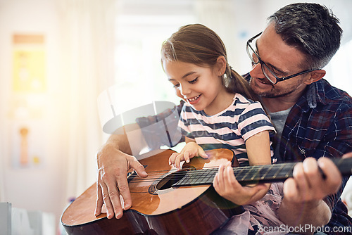 Image of Learning, guitar and girl, man with smile for music or bonding or love or play at house. Happiness, teaching and kid, father with acoustic or musical instrument for fun or education at family home.