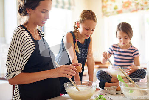 Image of Mother, family or kids baking in kitchen with siblings learning cookies recipe or mixing pastry at home. Girl, mom cooking or baker helping or teaching children to bake together for child development
