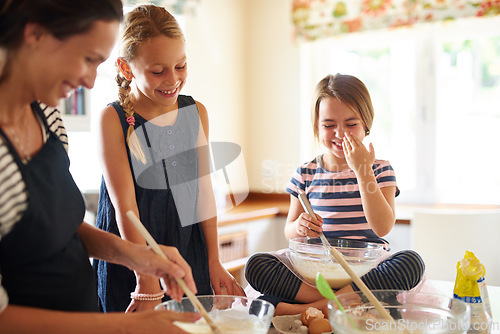 Image of Mom laughing, happy family or kids baking in kitchen with siblings learning or mixing cookies recipe. Funny, home or mother helping or teaching playful children to bake together for cooking skills