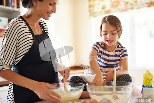 Image of Mother, cooking or girl child baking in kitchen as a happy family with a young kid learning cookies recipe. Cake, baker or mom helping or teaching daughter to bake for skills development at home