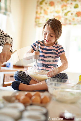 Image of Parent, girl or happy kid baking in kitchen as a family for learning cookies pastry or food recipe at home. Mixing, cooking or baker helping or teaching child to bake for skills development growth