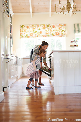 Image of Mother, oven or kid baking in kitchen as a happy family with a young girl learning cookies recipe at home. Cake, girl baker or mom helping or teaching daughter to bake in stove for child development
