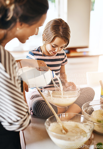 Image of Mother, milk or girl baking in kitchen as a happy family with a kid learning cookies or cake recipe at home. Smile, cooking or mother baker helping or teaching daughter to bake for child development