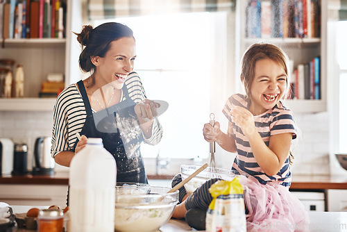 Image of Mother, play or kid baking in kitchen as a happy family with an excited girl laughing or learning cookies recipe. Playful, flour or funny mom helping or teaching kid to bake for development at home