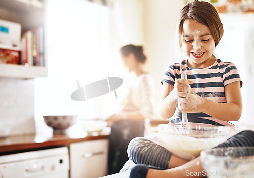 Image of Messy, happy and child baking in the kitchen with parent for bonding, food and dessert. Funny young girl mixing flour in a bowl with chaos, energy or cooking with happiness while playing for learning