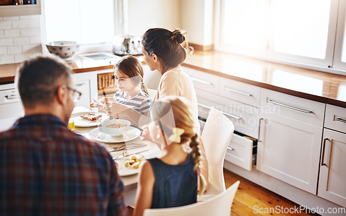 Image of Family, morning and breakfast by table in kitchen for meal, eating or bonding time together at home. Mother, father and children with healthy food to start the day for nutrition or cereal in house