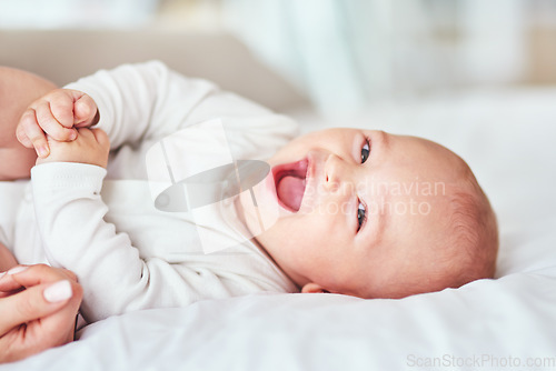 Image of Laugh, portrait and a baby on the bed with mother for play, bonding and wake up in the morning. Smile, house and a little newborn child in the bedroom for happiness, care and together with mom