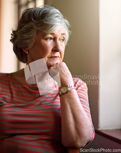 Image of Senior woman, sad and thinking at window for memory, ideas and home on living room sofa. Elderly lady, remember and worry with decision, mental health and retirement on lounge chair, fear and anxiety