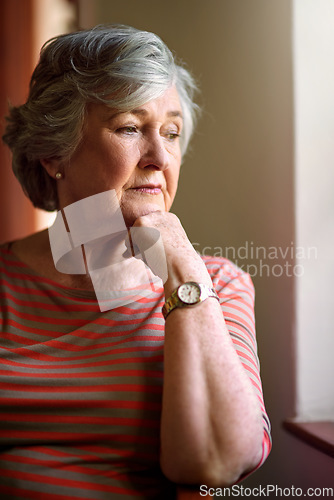 Image of Senior woman, worried and thinking at window for memory, ideas or home on living room sofa. Elderly lady, remember and think for decision, mental health or retirement on lounge chair, fear or anxiety