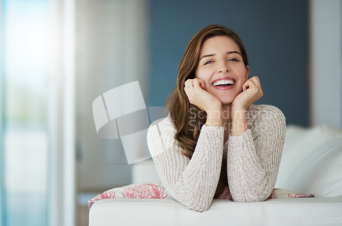 Image of Portrait, happy and woman relax on sofa in home living room laughing at comedy. Face, smile or excited female person from Canada on couch in lounge, apartment or house to enjoy me time, joke or funny
