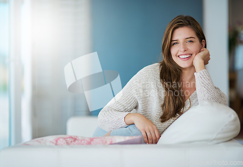 Image of Portrait, happy and woman relax in home living room for easy lifestyle on sofa. Face, smile and young person from Canada on couch in lounge, apartment or house to enjoy me time, break or mockup space