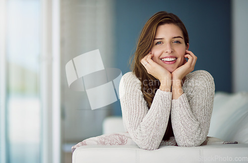 Image of Smile, portrait and woman relax on couch in home living room on holiday. Face, happy and young female person from Canada on sofa in lounge, apartment or house to enjoy me time, vacation or lifestyle.