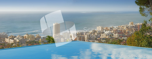 Image of Travel, ocean and infinity pool in city on vacation and hotel view in Cape Town with nobody, buildings and urban beach property. Cityscape, sea and sky at luxury accommodation for summer holiday trip