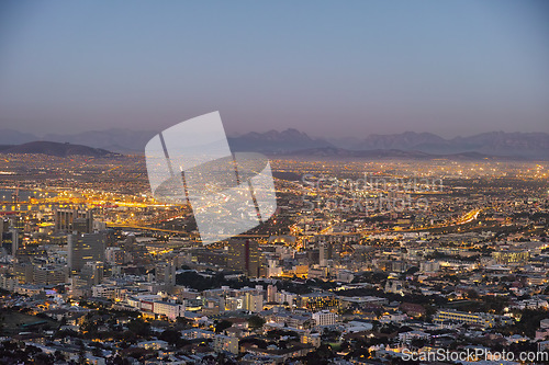 Image of Night, cityscape and urban buildings, architecture or infrastructure for development, expansion and property. Skyline, cbd and mountains with city skyscraper, commercial road or space in Cape Town