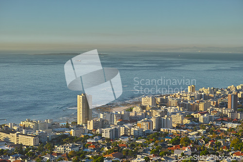 Image of Cityscape, urban buildings and architecture by ocean, infrastructure and property development in metro. Skyline, cbd and seaside with city skyscraper, Cape Town and mockup space in summer sunshine