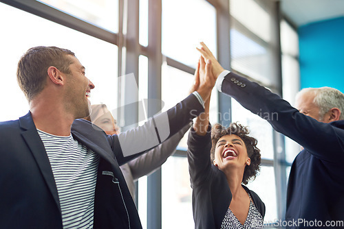 Image of Business people, group high five and happy in office with teamwork, smile and support for company goals. Men, women and hands in air for team building, achievement and celebration at insurance agency