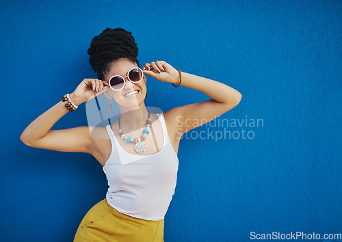 Image of Fashion, sunglasses and portrait of woman on blue background, wall and summer streetwear, trendy clothes or shades mockup. Girl, happy and excited model with cool style, vision and urban mock up