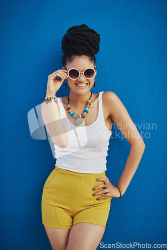 Image of Fashion, portrait and woman with sunglasses on blue background, wall and summer streetwear, trendy clothes or shades mockup. Girl, happy and excited model with cool style, vision and urban mock up