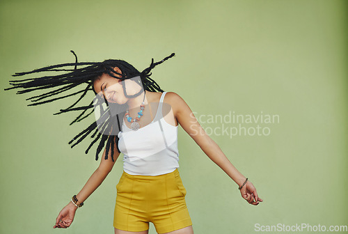 Image of Happy, dance and freedom with black woman in studio for energy, natural and hip hop. Happiness, talent and culture with african female dancer on green background for mockup, motivation and crazy