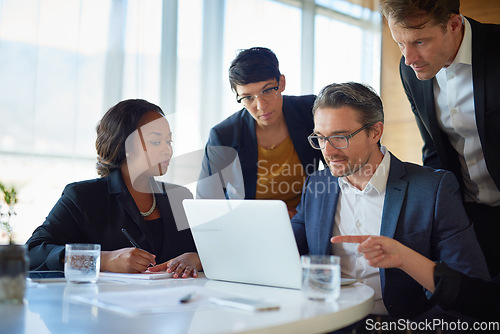 Image of Planning, stock brokers working with laptop and in a boardroom of their workplace. Collaboration or teamwork, brainstorming or finance and coworkers at desk in a modern office discussing a project