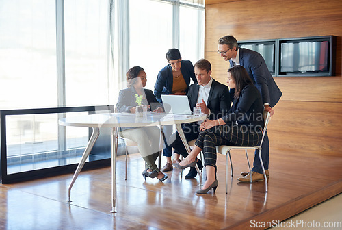 Image of Discussion, collaboration and team in a meeting with laptop for corporate planning in the office. Teamwork, technology and group of professional employees working on project together in the workplace