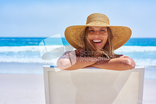 Image of Portrait, beach and woman with a smile, holiday and summer getaway with tourism, break or travelling. Face, female person or girl on a chair, seaside vacation or travel with a hat or relax with waves