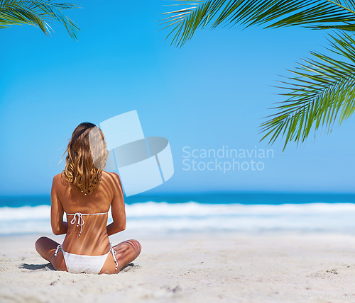 Image of Tropical, ocean and back of woman on beach on sand for adventure, holiday and vacation in Mauritius. Travel, mockup space and female person relax in bikini on island for summer, tourism and getaway