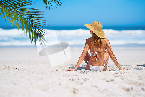 Image of Tropical, beach and woman relax on island on sand for adventure, holiday and vacation in Mauritius. Travel mockup, ocean and back of female person in bikini by sea for summer, traveling and getaway