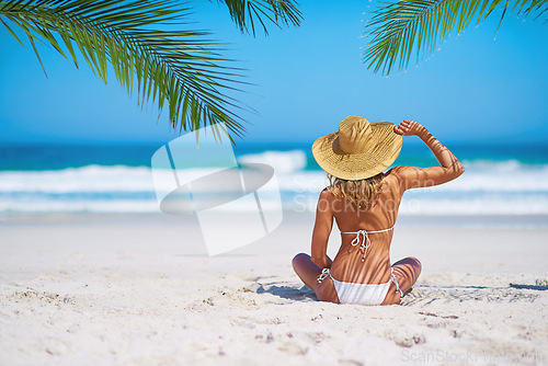 Image of Tropical island, beach and back of woman for summer adventure, holiday and vacation in Mauritius. Travel mockup, ocean and female person relax in bikini on sand for tourism, traveling and getaway