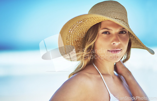 Image of Travel, space and portrait of woman at beach for summer vacation, tropical and relax mockup. Wellness, nature and holiday with face of female tourist and hat at seaside for sunbathing and paradise