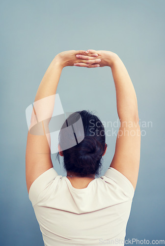 Image of Woman, work and stretching arms on studio, blue background or tired body from working, bad posture or strain. Stretch, arm and hands or businesswoman focus on care of back pain and stress management