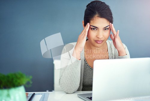 Image of Business woman, headache and laptop in office with hands, portrait and anxiety at desk at startup. Young businesswoman, burnout and pain with fatigue, frustrated and stress for glitch in workplace